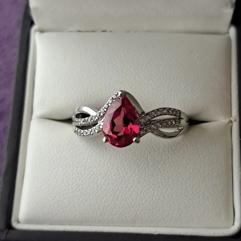 Padparadscha Sapphire & White Zircon Accented Triple Shank Ring.